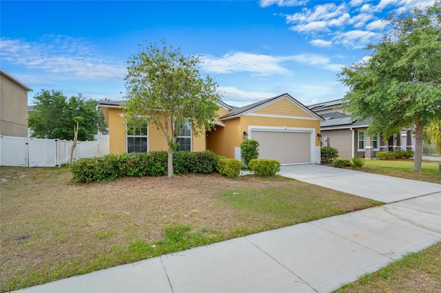 view of front of home featuring a front yard, a garage, driveway, stucco siding, and fence