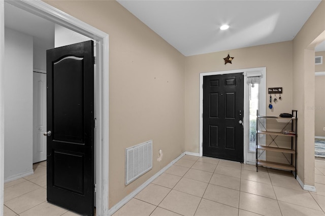 entryway featuring baseboards, visible vents, and light tile patterned flooring