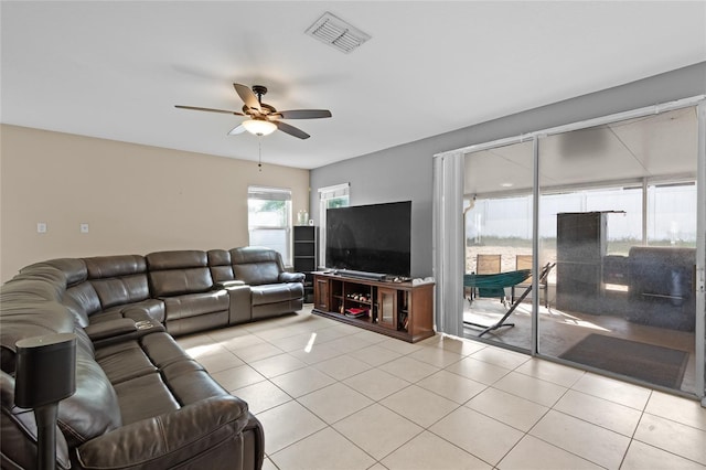 tiled living area with visible vents and a ceiling fan