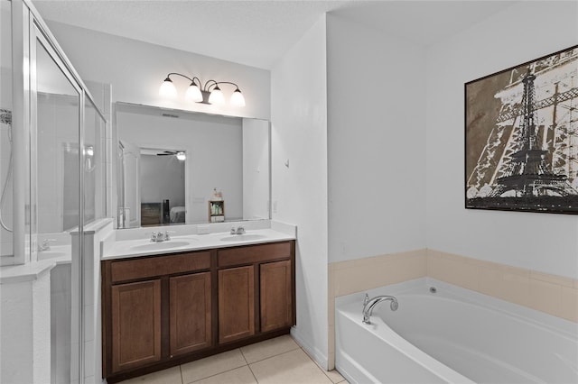 ensuite bathroom featuring a stall shower, tile patterned flooring, a sink, and a bath