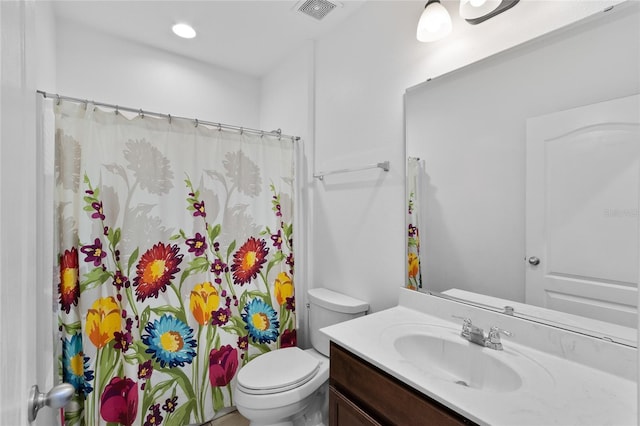 bathroom featuring toilet, visible vents, vanity, and curtained shower