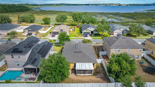 drone / aerial view with a water view and a residential view