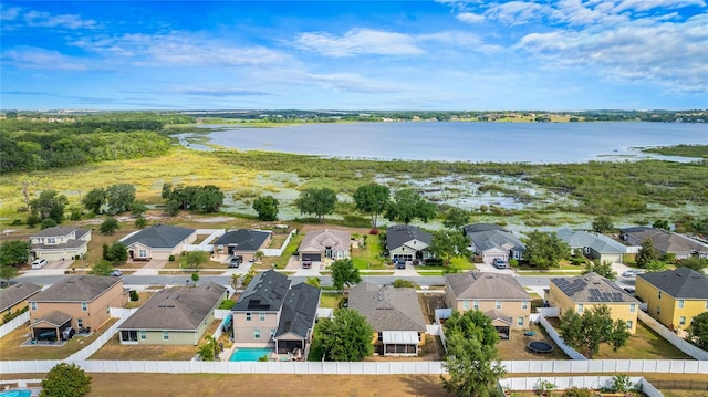 drone / aerial view with a residential view and a water view