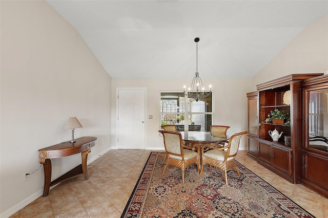 dining space featuring light tile patterned floors, a chandelier, lofted ceiling, and baseboards