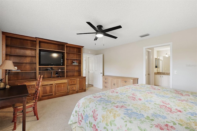 bedroom featuring light colored carpet, visible vents, ceiling fan, and a textured ceiling