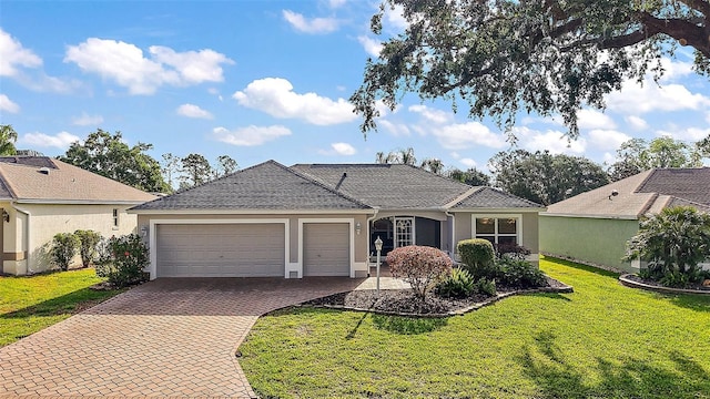 ranch-style home featuring a garage, stucco siding, decorative driveway, and a front yard