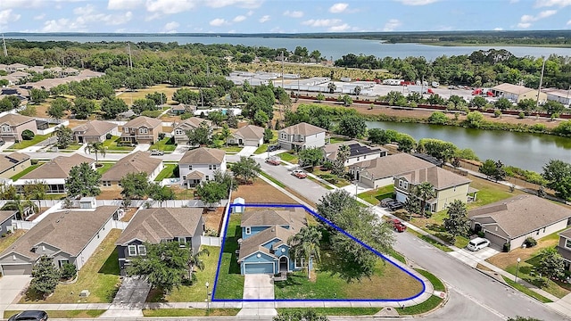 drone / aerial view featuring a residential view and a water view