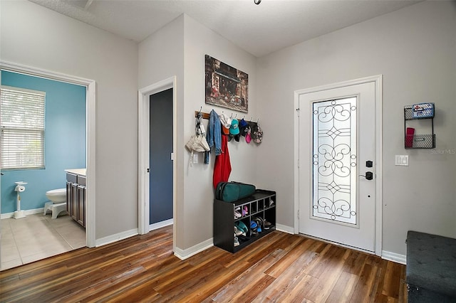 entryway with baseboards and hardwood / wood-style flooring