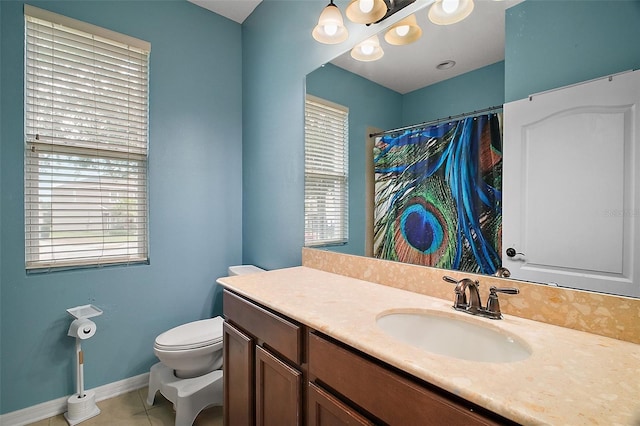 bathroom with a shower with curtain, vanity, toilet, baseboards, and tile patterned flooring