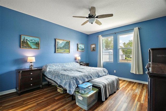 bedroom with a textured ceiling, wood finished floors, a ceiling fan, and baseboards