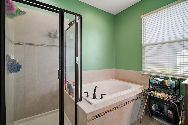 full bathroom featuring a garden tub and a shower stall