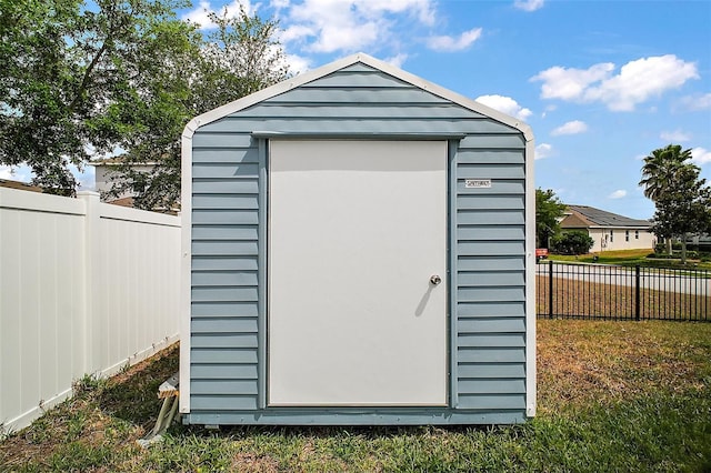 view of shed with fence