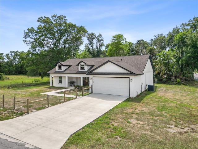modern farmhouse featuring fence, driveway, roof with shingles, a front yard, and an attached garage