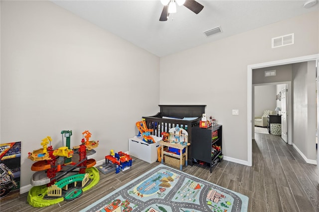 playroom featuring wood finished floors, visible vents, ceiling fan, and baseboards