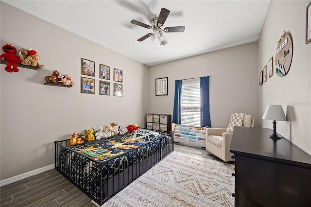 bedroom with wood finished floors, ceiling fan, and baseboards