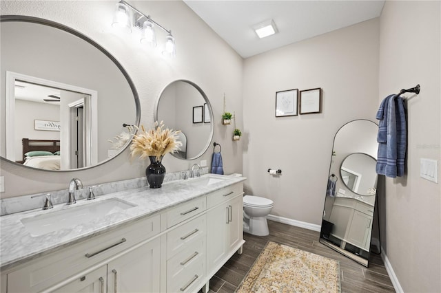 bathroom with a sink, baseboards, and ensuite bath