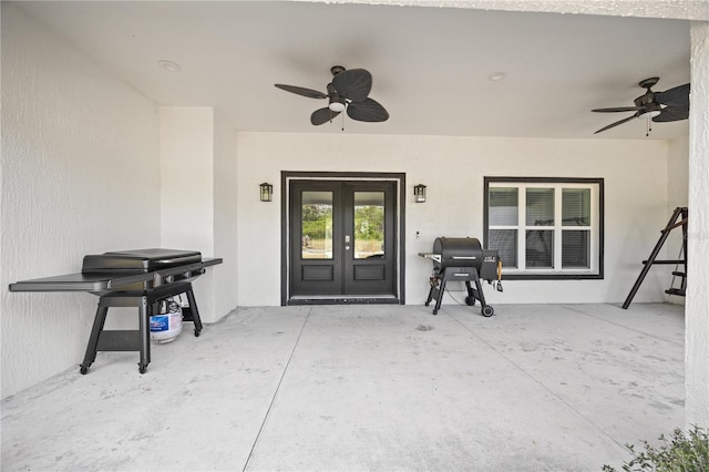 doorway to property featuring a patio, ceiling fan, stucco siding, and french doors