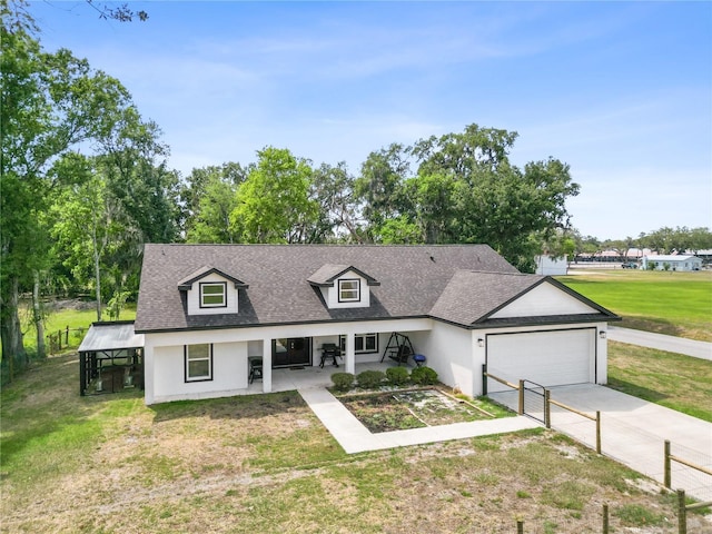 cape cod house featuring stucco siding, a garage, roof with shingles, a front yard, and concrete driveway