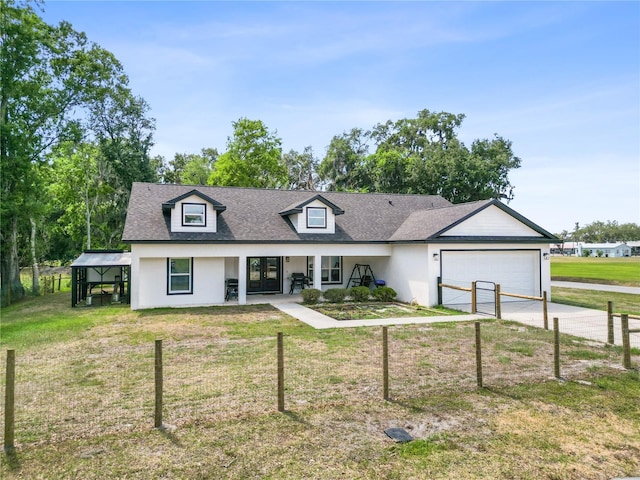 view of front facade featuring stucco siding, a front yard, concrete driveway, and an attached garage
