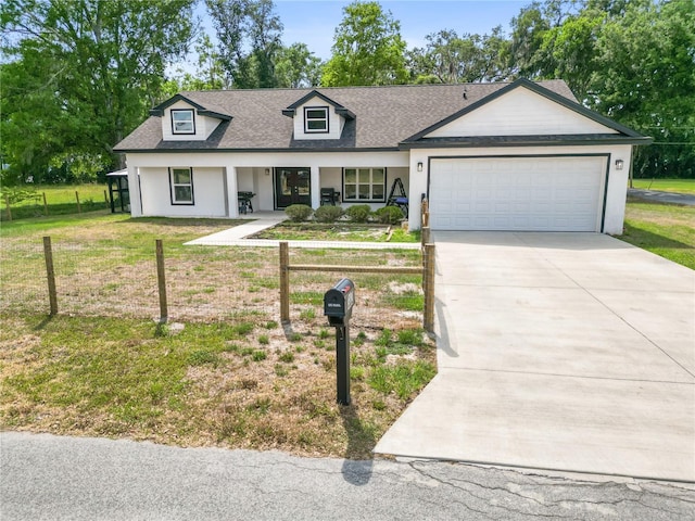 view of front of house with driveway, an attached garage, covered porch, and fence