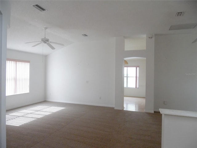 739 Cortez Ave, The Villages, FL 32159 - carpeted empty room with arched walkways, a ceiling fan, healthy amount of natural light, and vaulted ceiling