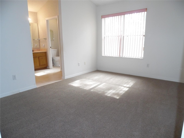 739 Cortez Ave, The Villages, FL 32159 - unfurnished bedroom featuring carpet flooring and ensuite bathroom
