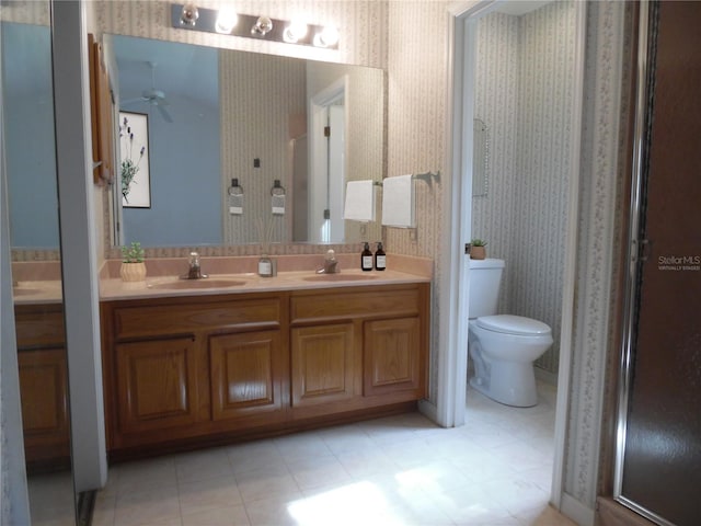 739 Cortez Ave, The Villages, FL 32159 - full bath featuring double vanity, wallpapered walls, a ceiling fan, and a shower stall