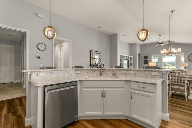 8492 Hartford Way, Mount Dora, FL 32757 - kitchen with stainless steel dishwasher, dark wood-style flooring, vaulted ceiling, light stone countertops, and a chandelier