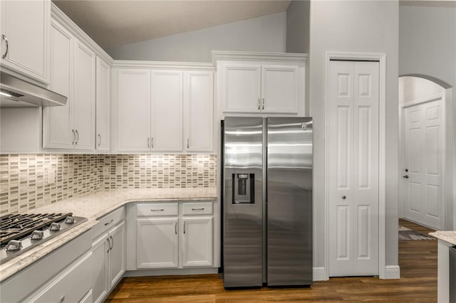 8492 Hartford Way, Mount Dora, FL 32757 - kitchen featuring appliances with stainless steel finishes, white cabinets, decorative backsplash, vaulted ceiling, and dark wood-type flooring