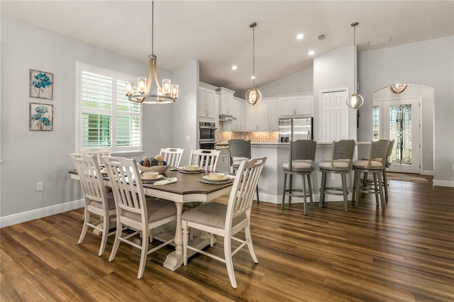 8492 Hartford Way, Mount Dora, FL 32757 - dining area featuring a chandelier, dark wood finished floors, plenty of natural light, recessed lighting, and vaulted ceiling