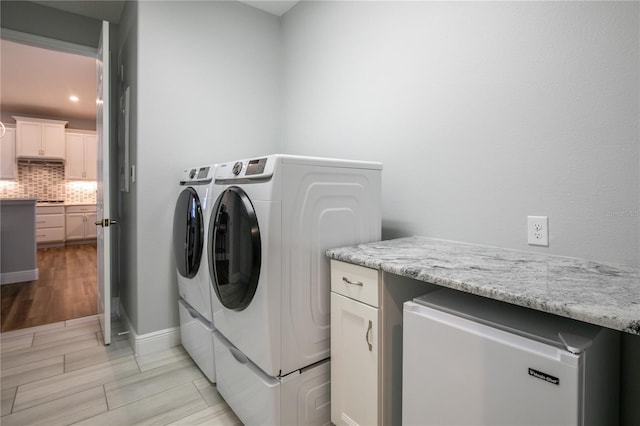 8492 Hartford Way, Mount Dora, FL 32757 - laundry room featuring independent washer and dryer, light wood finished floors, and recessed lighting