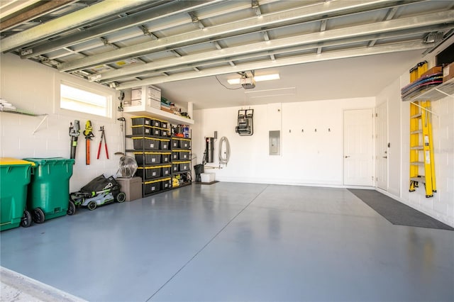 8492 Hartford Way, Mount Dora, FL 32757 - garage featuring a garage door opener, concrete block wall, and electric panel
