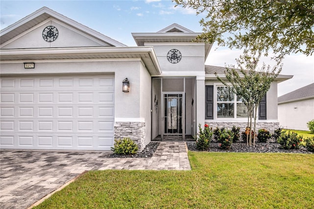 8492 Hartford Way, Mount Dora, FL 32757 - view of front facade featuring stone siding, stucco siding, a front yard, an attached garage, and driveway