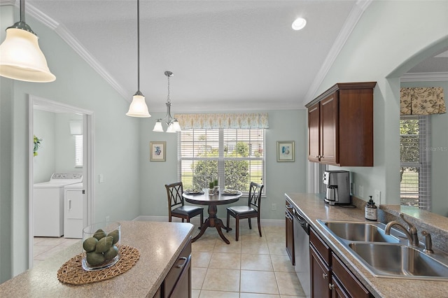 1140 Eureka Mill Run, The Villages, FL 32162 - kitchen featuring a sink, lofted ceiling, arched walkways, light tile patterned floors, and washing machine and dryer
