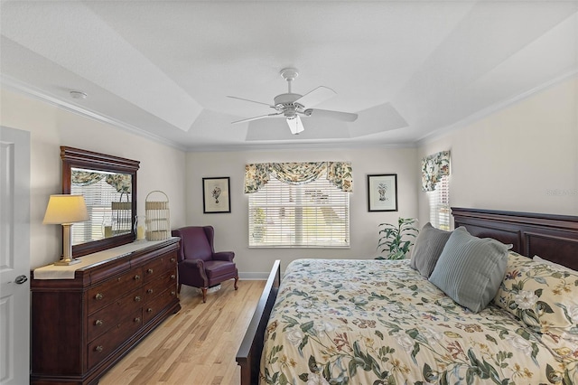 1140 Eureka Mill Run, The Villages, FL 32162 - bedroom with a tray ceiling, multiple windows, light wood-style floors, and ornamental molding