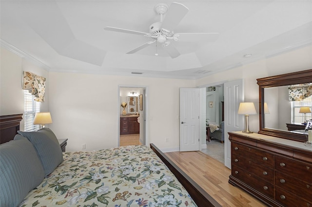 1140 Eureka Mill Run, The Villages, FL 32162 - bedroom with a tray ceiling, ornamental molding, ceiling fan, visible vents, and light wood-type flooring