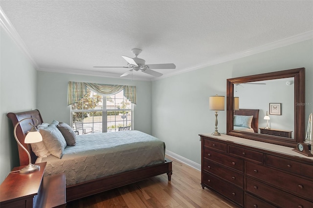 1140 Eureka Mill Run, The Villages, FL 32162 - bedroom with a ceiling fan, light wood-style flooring, a textured ceiling, baseboards, and crown molding