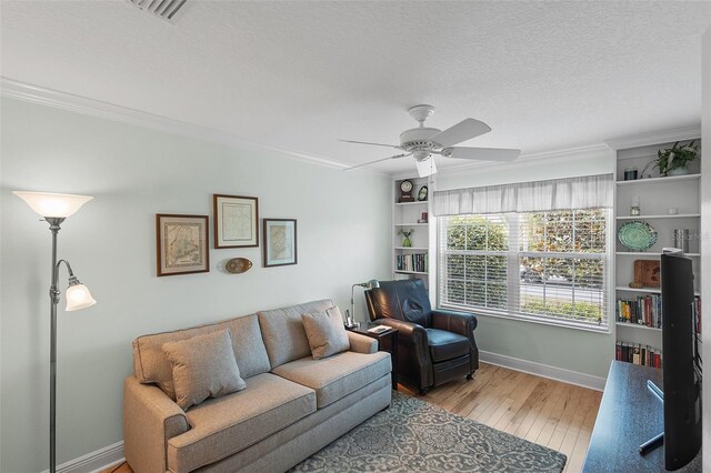1140 Eureka Mill Run, The Villages, FL 32162 - living room featuring visible vents, baseboards, ornamental molding, and hardwood / wood-style flooring