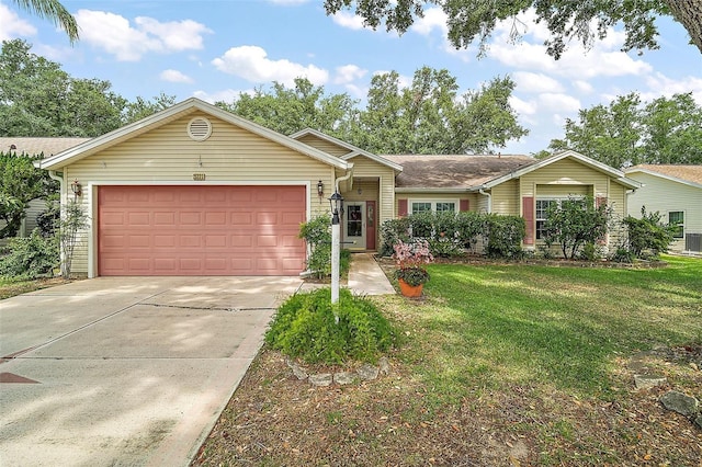 ranch-style house featuring a front yard, concrete driveway, and a garage