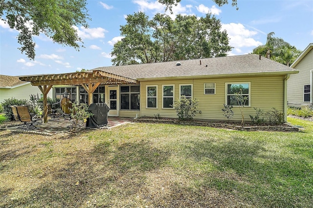 back of house featuring a patio, a yard, and a pergola