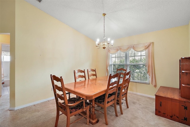 dining space with a textured ceiling, a notable chandelier, light colored carpet, and baseboards