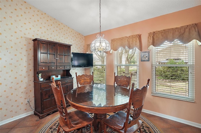 tiled dining room with baseboards, wallpapered walls, a notable chandelier, and vaulted ceiling