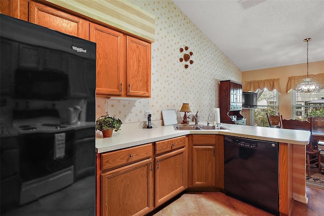 kitchen featuring a sink, light countertops, wallpapered walls, black appliances, and a peninsula