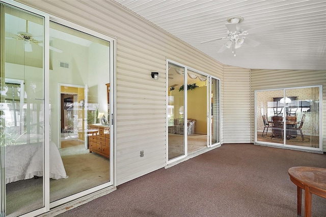 unfurnished sunroom with ceiling fan and visible vents