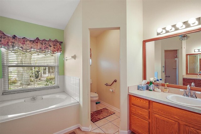 bathroom featuring a shower stall, toilet, tile patterned floors, a garden tub, and vanity