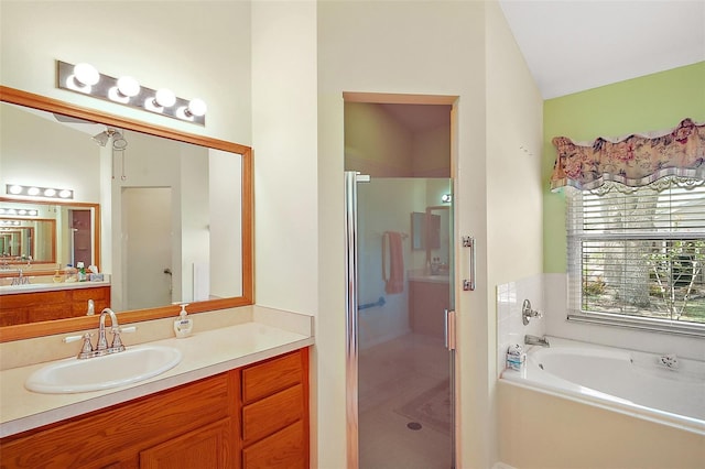 bathroom with a garden tub, vanity, and a stall shower