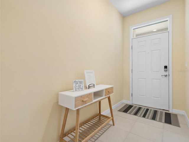 foyer entrance with tile patterned floors and baseboards