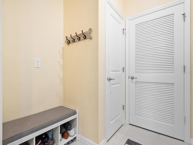 mudroom with light tile patterned floors and baseboards