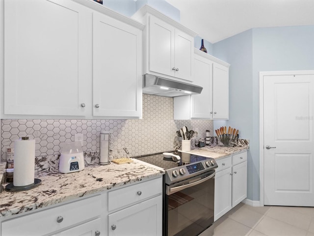 kitchen with stainless steel electric stove, backsplash, white cabinetry, and under cabinet range hood