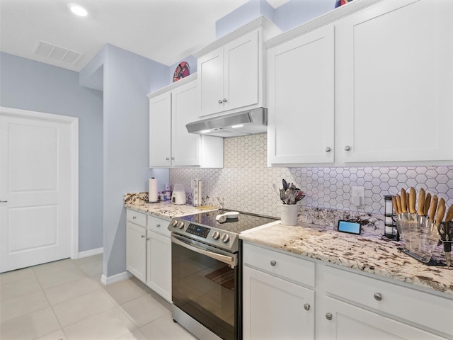 kitchen featuring electric stove, tasteful backsplash, under cabinet range hood, white cabinets, and visible vents